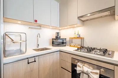 a kitchen with a sink and a stove at Sobha Crest Luxury Apartments in Dubai