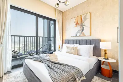 a bedroom with a large bed and a large window at Sobha Crest Luxury Apartments in Dubai