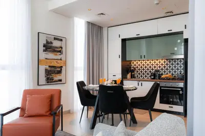 a kitchen and dining room with a table and chairs at Modern Amenities - Great Community in Dubai