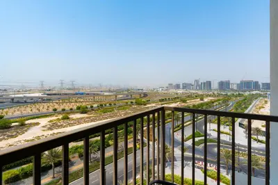 a view of a city from a balcony at Modern Amenities - Great Community in Dubai