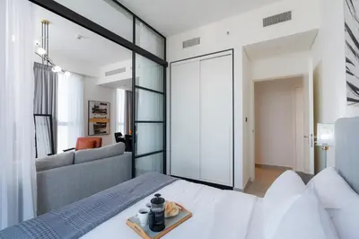 a bedroom with a white bed and a couch at Modern Amenities - Great Community in Dubai