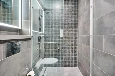 a bathroom with a shower with a glass door at STAY BY LATINEM Luxury 1BR Holiday Home CB 3602 Near Burj Khalifa in Dubai