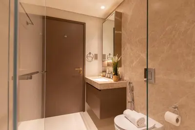 a bathroom with a shower and a toilet and a sink at 1BR Sea View at Grand Bleu - Emaar Beachfront in Dubai