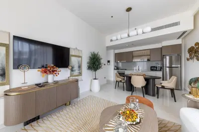 a living room with a kitchen and a dining room at 1BR Sea View at Grand Bleu - Emaar Beachfront in Dubai