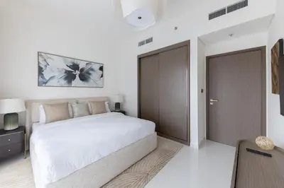 a bedroom with a bed and a sliding door at 1BR Sea View at Grand Bleu - Emaar Beachfront in Dubai