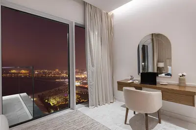 a room with a desk and a view of a city at La Brisa Exclusive 3BHK at 1JBR Sea Palm Royal Atlantis Burj AlArab View with Private Beach and Pool By La Brisa Dubai in Dubai