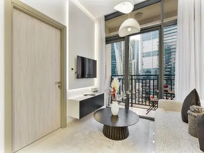 a living room with a couch and a table at Savis Homes - Zada Tower Luxury Escape - Close to Dubai Mall & Burj Khalifa in Dubai