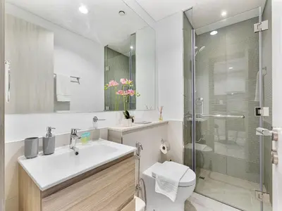 a bathroom with a toilet and a sink and a shower at Savis Homes - Zada Tower Luxury Escape - Close to Dubai Mall & Burj Khalifa in Dubai