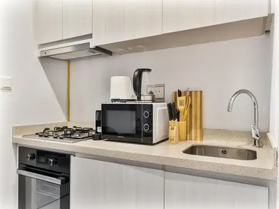 a kitchen with a microwave and a sink at Savis Homes - Zada Tower Luxury Escape - Close to Dubai Mall & Burj Khalifa in Dubai