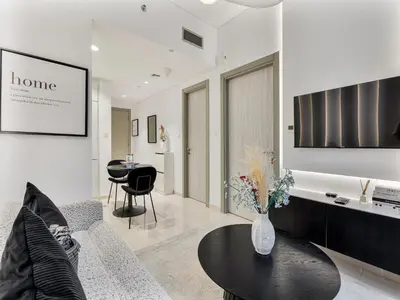 a living room with a vase of flowers on a table at Savis Homes - Zada Tower Luxury Escape - Close to Dubai Mall & Burj Khalifa in Dubai