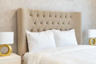 a bedroom with a bed with white pillows and two lamps at Stunning Burj View High Floor EB in Dubai