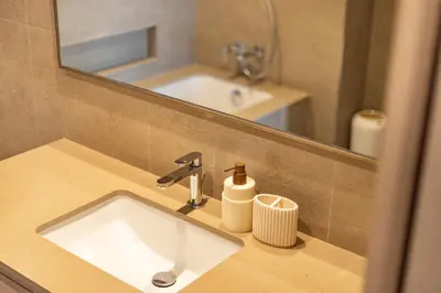 a bathroom with a sink and a mirror and a sink at Stunning Burj View High Floor EB in Dubai