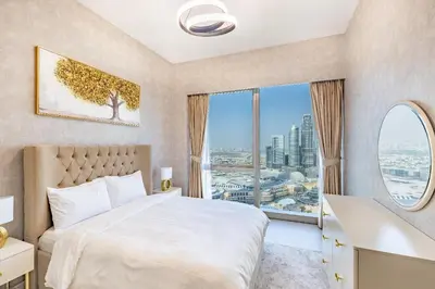 a bedroom with a bed and a large window at Stunning Burj View High Floor EB in Dubai