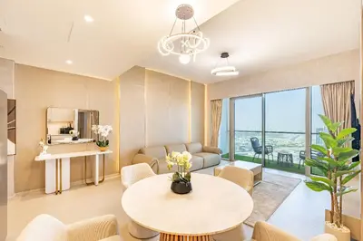 a living room with a table and a couch at Stunning Burj View High Floor EB in Dubai
