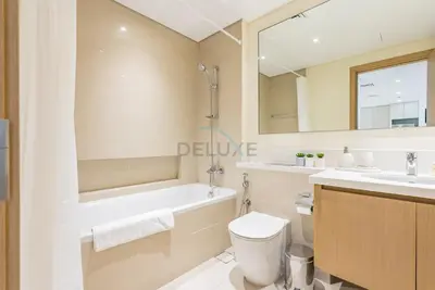 a bathroom with a tub and a toilet and a sink at Partial Creek Harbour Views, Close to the Creek Harbour Marine Station and Harbour Promenade, Just Minutes from a Park, Harbour Views Tower 2, Dubai Creek Harbour by Deluxe Holiday Homes in Dubai