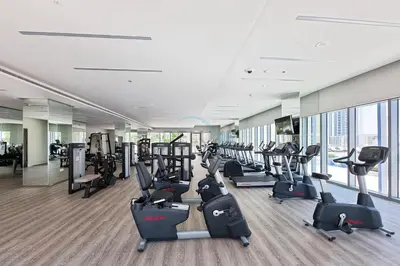 a gym with treadmills and cardio equipment in a building at Partial Creek Harbour Views, Close to the Creek Harbour Marine Station and Harbour Promenade, Just Minutes from a Park, Harbour Views Tower 2, Dubai Creek Harbour by Deluxe Holiday Homes in Dubai