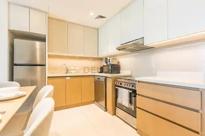 a kitchen with white cabinets and a stainless steel appliance at Partial Creek Harbour Views, Close to the Creek Harbour Marine Station and Harbour Promenade, Just Minutes from a Park, Harbour Views Tower 2, Dubai Creek Harbour by Deluxe Holiday Homes in Dubai