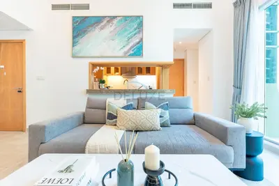 a living room with a couch and a table at Next to Marina Canal 1BR, Easily Accessible from the Tram, a Short Stroll to Marina Beach and The Walk, Beauport X1, Dubai Marina - by Deluxe Holiday Homes in Dubai