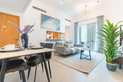 a living room with a table and a couch at Next to Marina Canal 1BR, Easily Accessible from the Tram, a Short Stroll to Marina Beach and The Walk, Beauport X1, Dubai Marina - by Deluxe Holiday Homes in Dubai