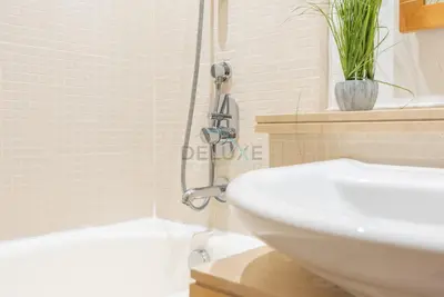 a bathroom with a shower and a white sink at Next to Marina Canal 1BR, Easily Accessible from the Tram, a Short Stroll to Marina Beach and The Walk, Beauport X1, Dubai Marina - by Deluxe Holiday Homes in Dubai