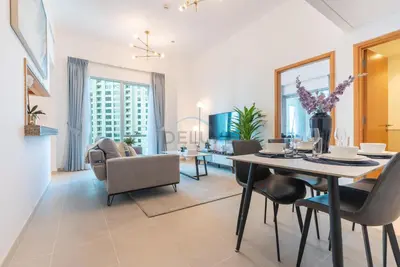 a dining room and living room with a table and chairs at Next to Marina Canal 1BR, Easily Accessible from the Tram, a Short Stroll to Marina Beach and The Walk, Beauport X1, Dubai Marina - by Deluxe Holiday Homes in Dubai