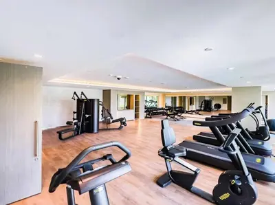 a gym with several treadmills and cardio machines at Elegant 1 Bedroom with Balcony in City Walk in Dubai