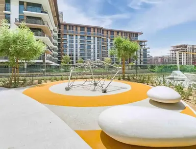 a sculpture in the middle of a park with a building at Elegant 1 Bedroom with Balcony in City Walk in Dubai