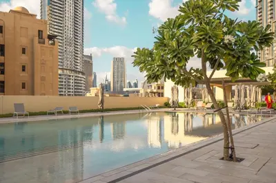 a swimming pool in a city with tall buildings at VayK - Stylish 1BR in Iconic Downtown Location in Dubai