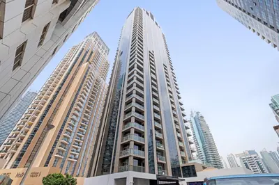 a tall building in a city with tall buildings at Vayk - Bright and Spacious 2BR with Panoramic Marina Views in Dubai