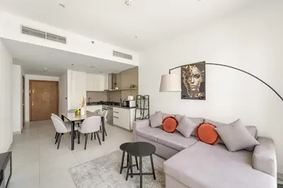 a living room with a couch and a table at Vayk - Bright and Spacious 2BR with Panoramic Marina Views in Dubai
