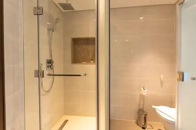 a shower with a glass door in a bathroom at PVH - Elegant 2BR near Dubai Mall - Opera Grand in Dubai