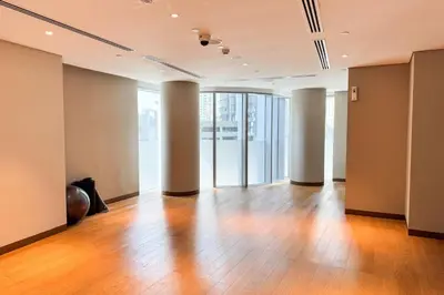 an empty room with wooden floors and large windows at PVH - Elegant 2BR near Dubai Mall - Opera Grand in Dubai
