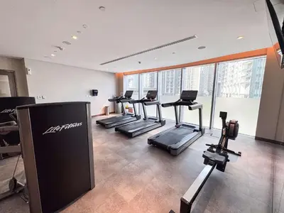 a gym with several treadmills and machines in a room at PVH - Elegant 2BR near Dubai Mall - Opera Grand in Dubai