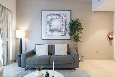a living room with a couch and a table at Luxury Grande Signature Apartment in Dubai Downtown Steps to Dubai Mall and Burj Khalifa with Stunning Pool View by La Brisa Dubai in Dubai
