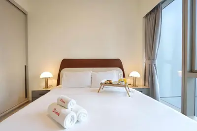 a bedroom with a bed with towels on it at Luxury Grande Signature Apartment in Dubai Downtown Steps to Dubai Mall and Burj Khalifa with Stunning Pool View by La Brisa Dubai in Dubai