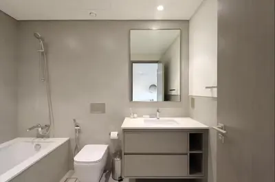 a bathroom with a sink and a toilet and a mirror at Luxury Grande Signature Apartment in Dubai Downtown Steps to Dubai Mall and Burj Khalifa with Stunning Pool View by La Brisa Dubai in Dubai