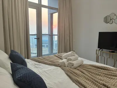 a bedroom with a bed with towels on it at Marina Sunset Haven - Breathtaking Views in Dubai