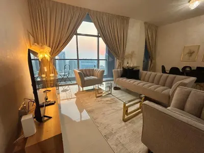 a living room with a couch and a table at Marina Sunset Haven - Breathtaking Views in Dubai