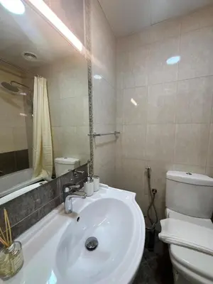 a bathroom with a white sink and a toilet at Marina Sunset Haven - Breathtaking Views in Dubai