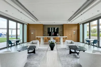 a living room with couches and tables and windows at Luxury 2BR Walk-In Closet Full Burj Khalifa View in Dubai