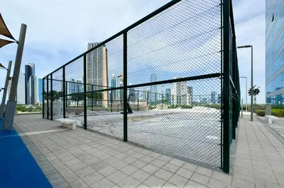 a chain link fence in front of a city at Luxury 2BR Walk-In Closet Full Burj Khalifa View in Dubai