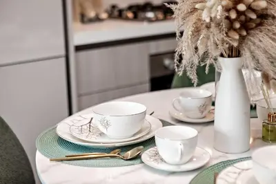 a table with three cups and saucers on it at Inspiring 1BR Apartment at Sobha Hartland in Dubai