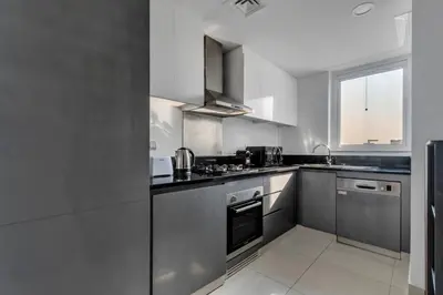 a kitchen with stainless steel appliances and a window at GuestReady - Damac Prive | 1BR Canal View in Dubai