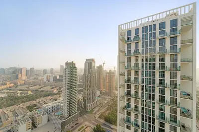 an aerial view of a city with a tall building at Cozy 1 Bedroom in JVC with Stunning City Views in Dubai