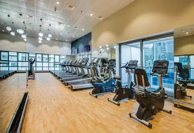 a gym with treadmills and elliptical machines at Full Luxury 2 Bedrooms Apartment, Princess Tower in Dubai