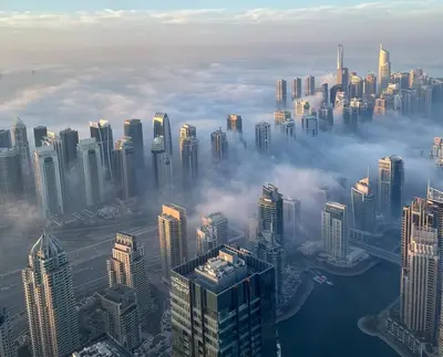 an aerial view of a city above the clouds at Full Luxury 2 Bedrooms Apartment, Princess Tower in Dubai