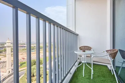 a balcony with a table and chairs and a view of the beach at STAY BY LATINEM Luxury 1BR Holiday Home CB 0810 Near Burj Khalifa in Dubai