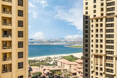 a view of the beach from between two buildings at Central JBR Home Steps away from the Beach in Dubai