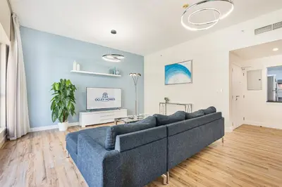 a living room with a couch and a tv at Central JBR Home Steps away from the Beach in Dubai