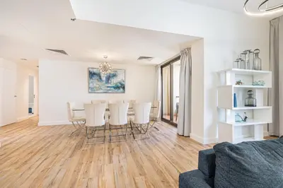 a living room with a table and chairs at Central JBR Home Steps away from the Beach in Dubai